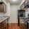 Spacious and well lit kitchen with wood flooring and stainless steel appliances