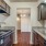 Spacious and well lit kitchen with wood flooring and stainless steel appliances