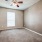 Large well lit bedroom with plush carpets and large windows 
