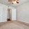 Large well lit bedroom with plush carpets and large windows 