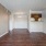 Spacious and well lit kitchen with wood flooring and stainless steel appliances