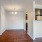 Spacious and well lit kitchen with wood flooring and stainless steel appliances