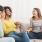 3 women on a couch laughing